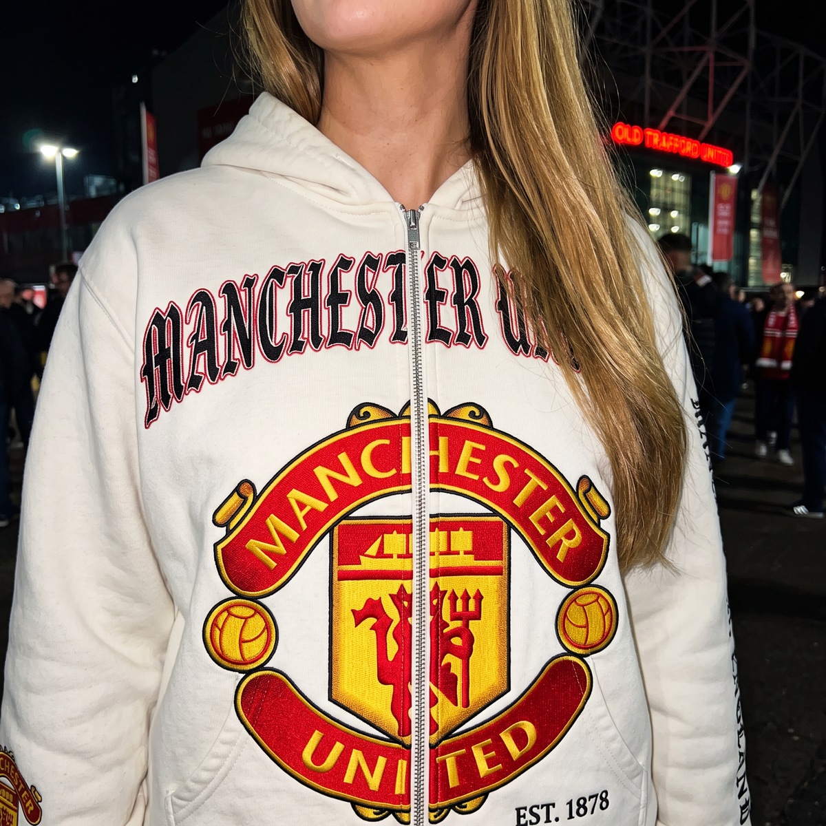 Close-up of the Manchester United MatchWorn hoodie fabric, crest and sleeve print